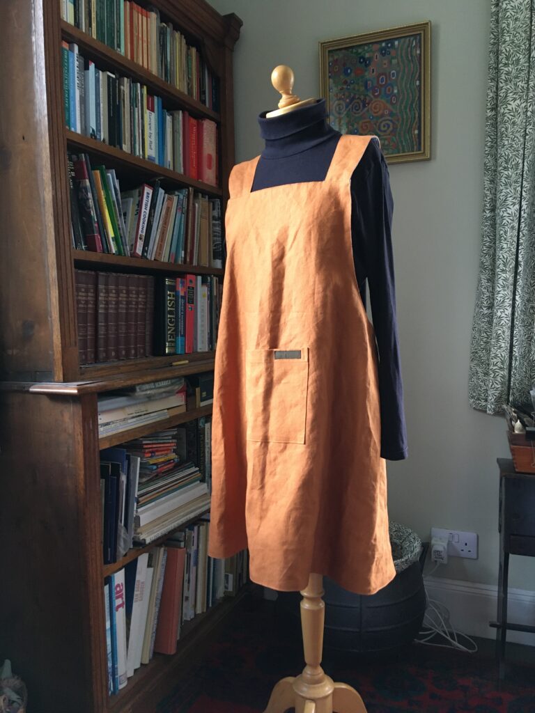 Front view of Pinny no 177, tobacco coloured linen