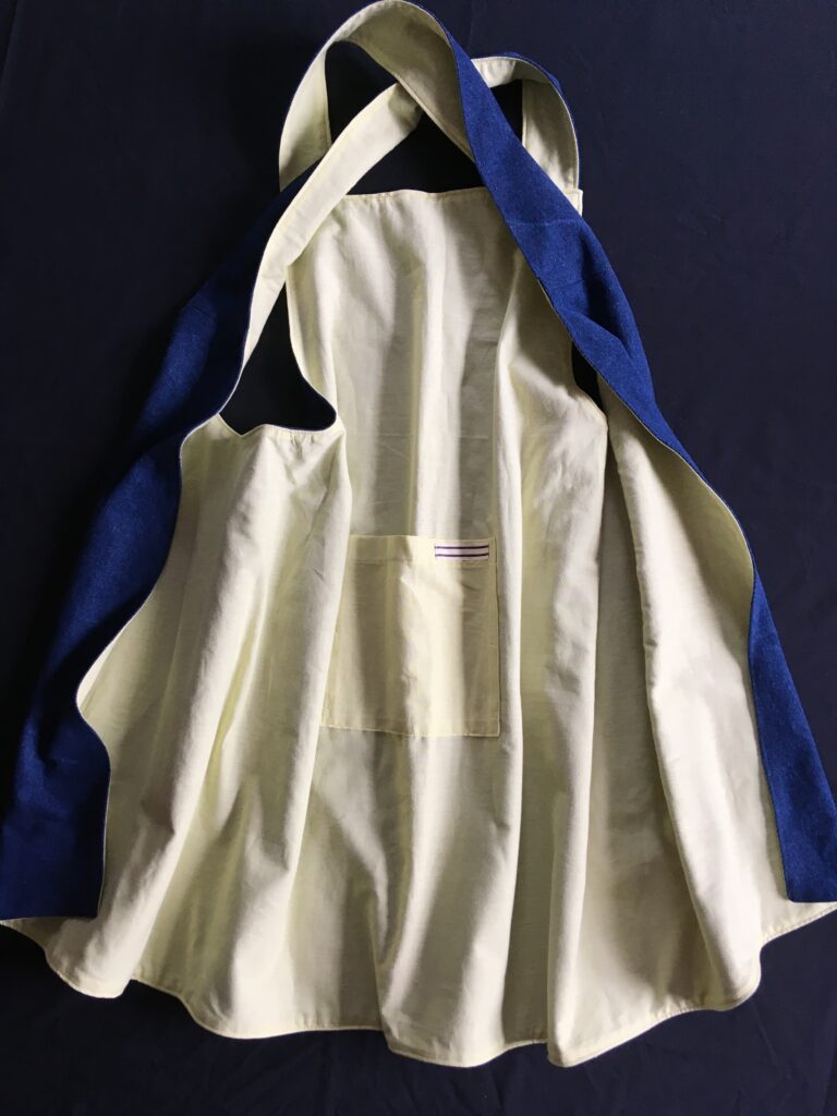 Pinny 189 Denim with citron yellow reverse, rear view