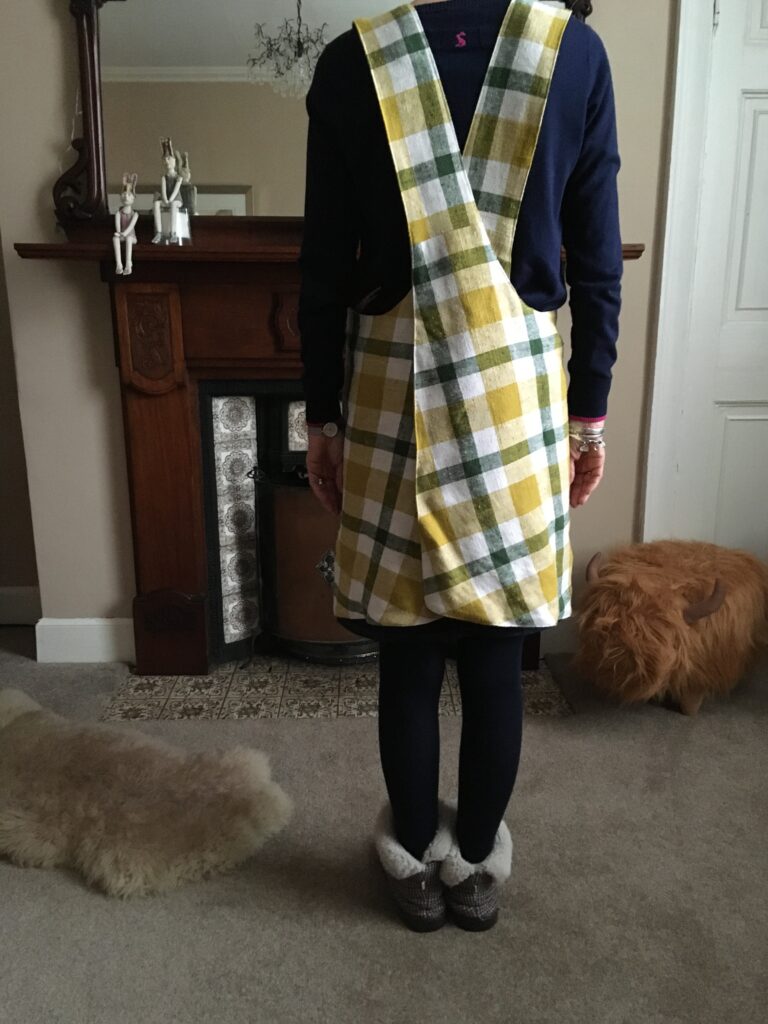 A size 8 person modelling a pinny