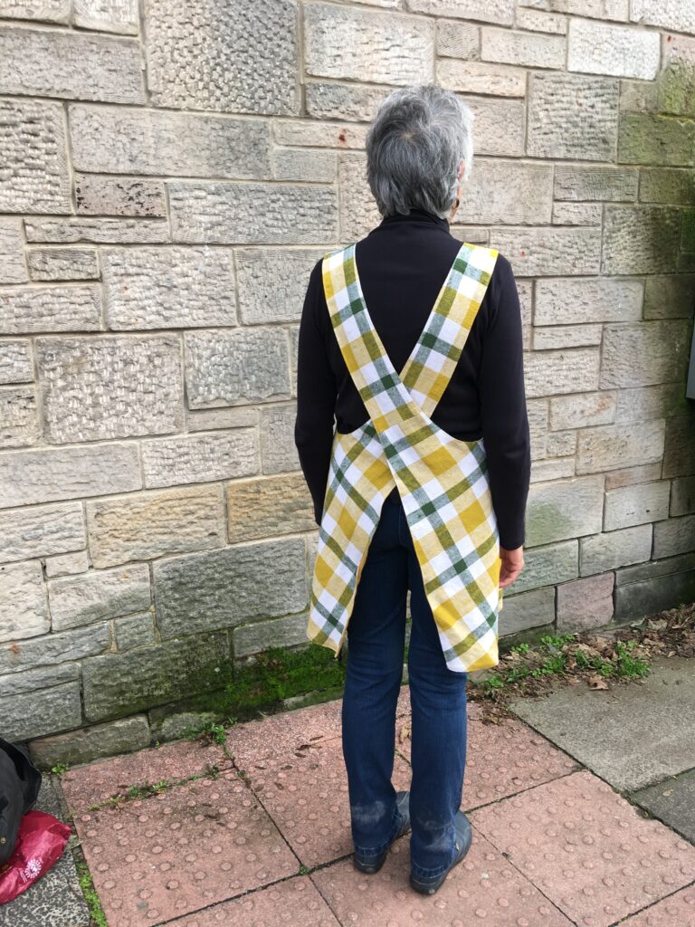 A size 12 person modelling a pinny